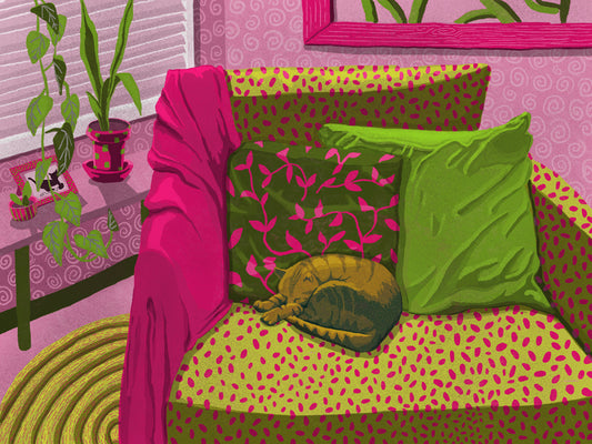 A ginger cat sleeps among pillows and a blanket on a lime green and magenta patterned chair in a pink room with plants by a window.