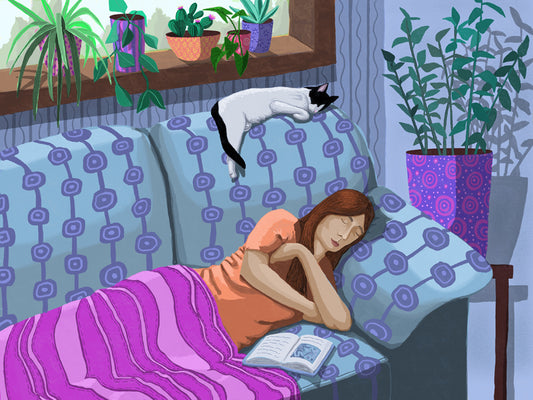 A woman and a tuxedo cat have a nap on a patterned couch in a room full of plants
