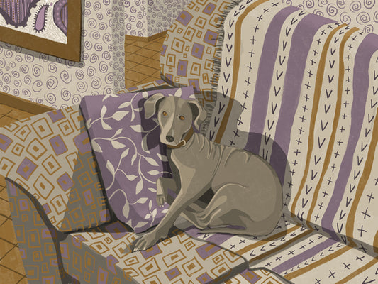 A grey dog rests against a dusty purple leaf patterned pillow on a grey, dusty purple and ochre patterned couch in a room